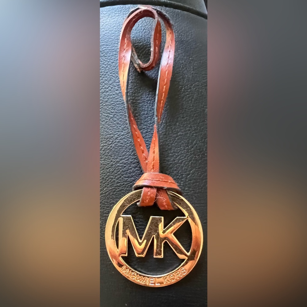 MK bag charm in gold with brown leather holder